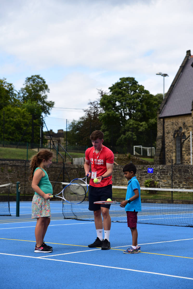 Children and coach playing tennis Sports coach with children