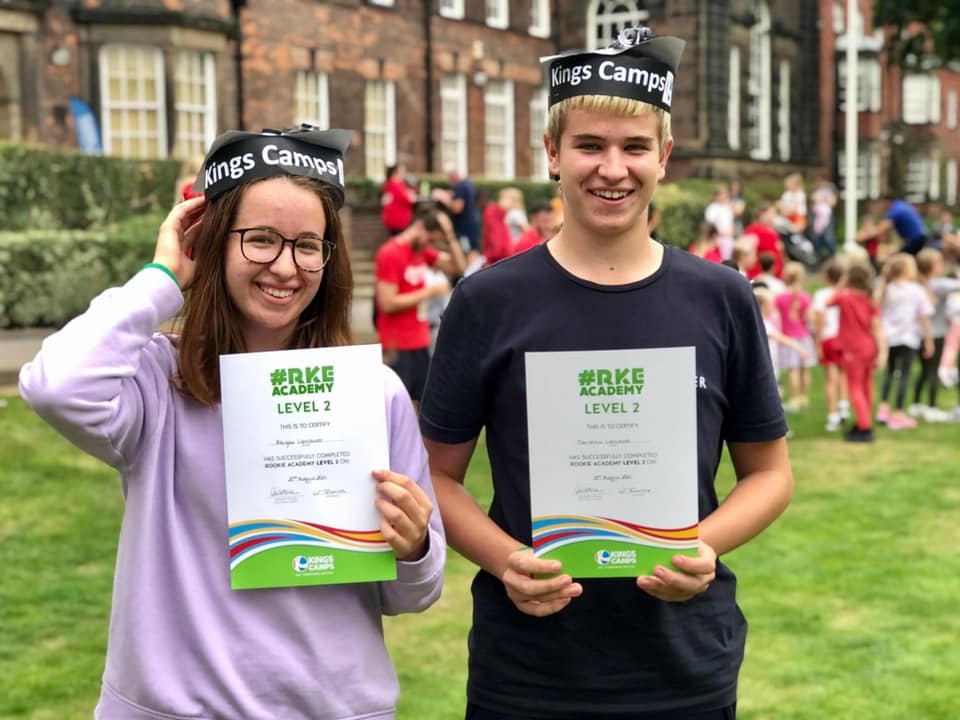 Two Rookie Academy Graduates holding their certificates